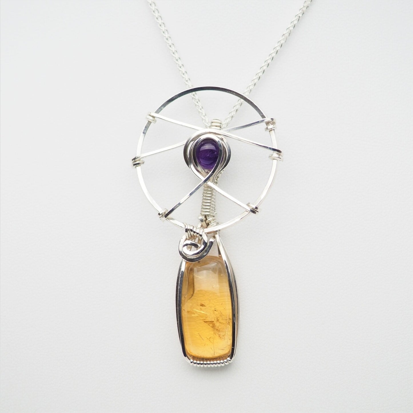 Citrine and Amethyst cabochons wrapped in Sterling Silver.