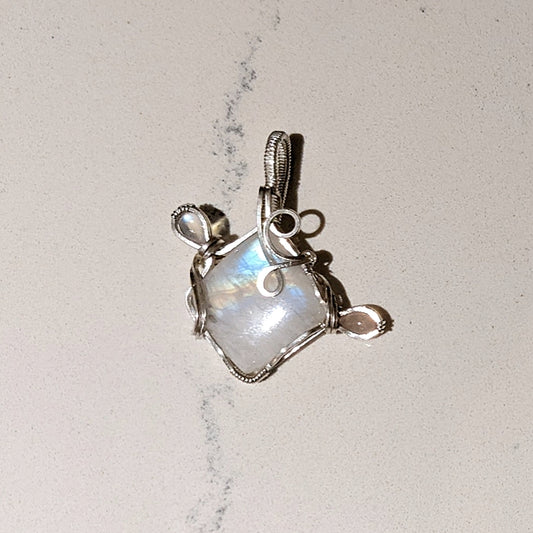 Rainbow Moonstone wrapped in Sterling Silver